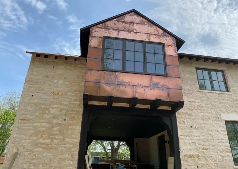Copper metal panel facade on a stone building for Skylight Installation in Cedar Rapids