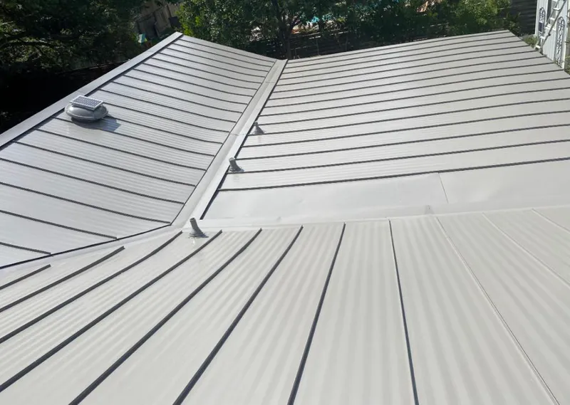 Solar attic fan installed on a metal roof for Roof Ventilation in Cedar Rapids