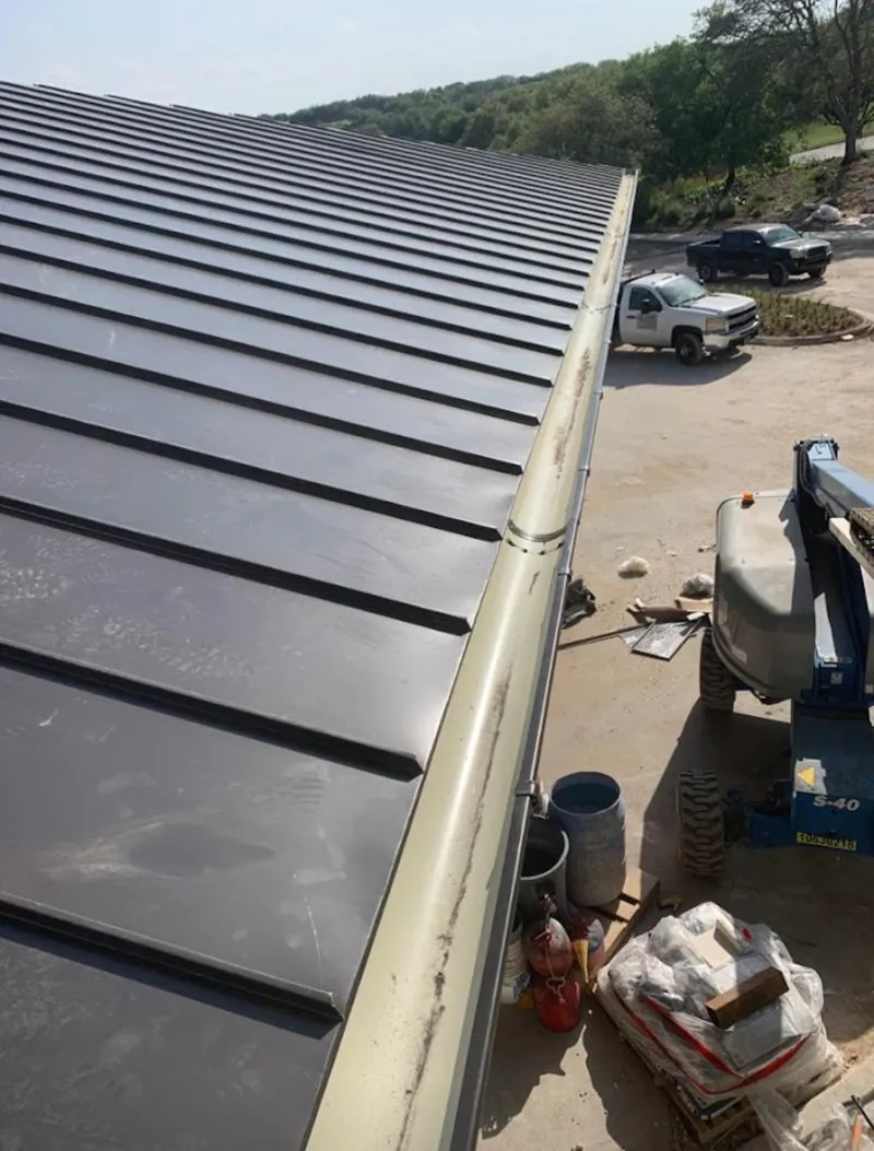 Standing seam panel and gutter detail on a metal roofing jobsite in Cedar Rapids
